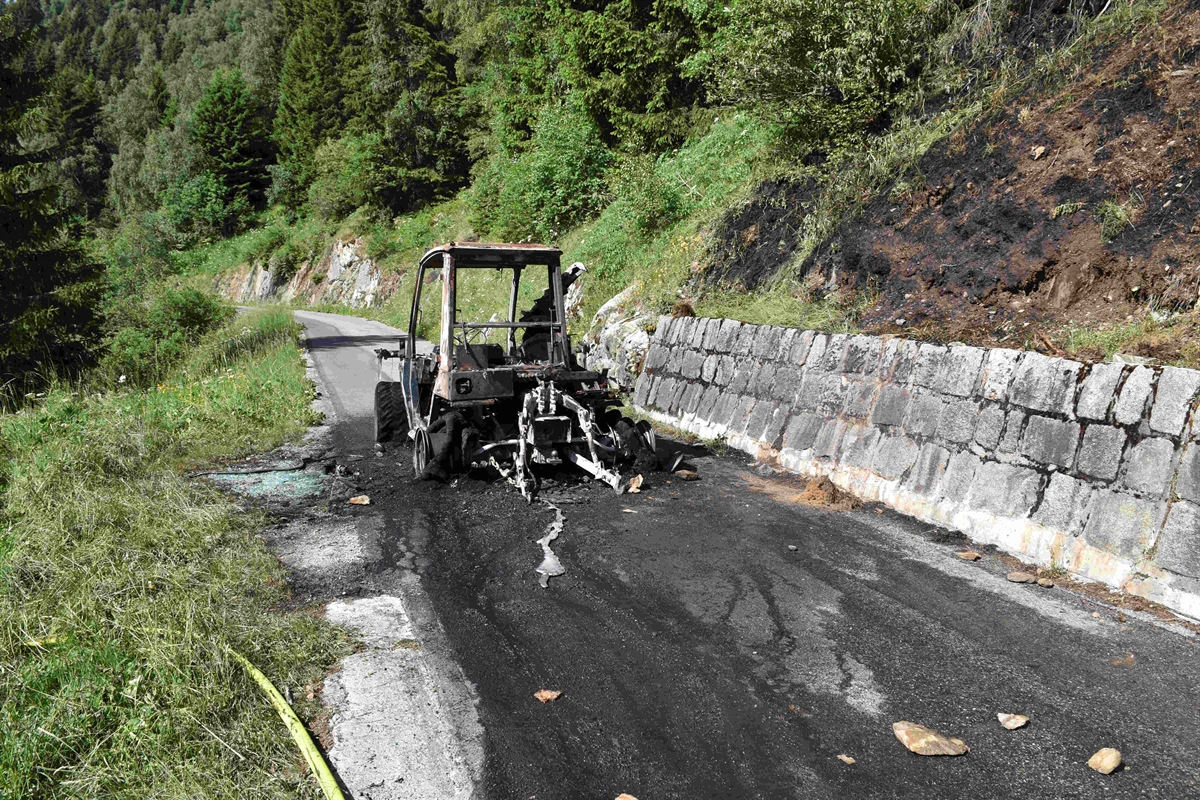 Ausgebrannter Traktor steht auf der Strasse.