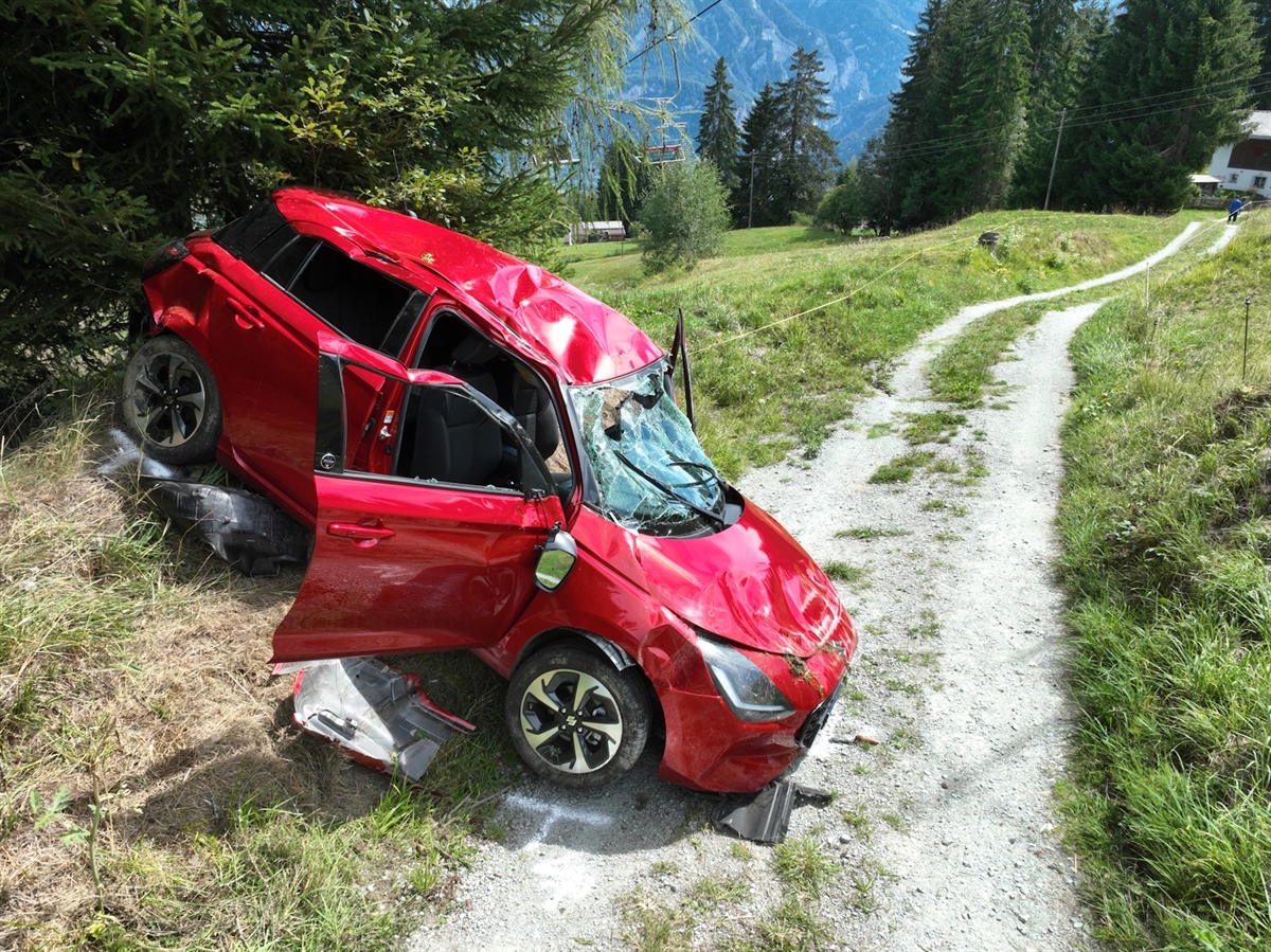 Das total beschädigte Unfallauto mit Heck in Richtung Böschung des Feldweges.