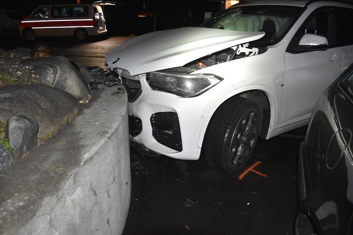 Auto mit defekter Frontscheibe frontal in Mauer, im Hintergrund Patrouillenfahrzeug